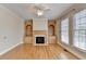 Bright living room with hardwood floors, fireplace, and built-in bookshelves at 870 Longstone Lndg, Alpharetta, GA 30022