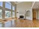Bright living room features hardwood floors, fireplace, and large windows with a view at 870 Longstone Lndg, Alpharetta, GA 30022