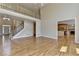Living room featuring hardwood floors, plenty of natural light, and access to kitchen at 870 Longstone Lndg, Alpharetta, GA 30022