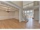 Spacious living room with hardwood floors, staircase, and a view of the dining room and fireplace at 870 Longstone Lndg, Alpharetta, GA 30022