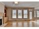 Sunlit living room featuring a fireplace, built-in shelving, and large windows at 870 Longstone Lndg, Alpharetta, GA 30022