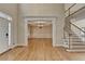 Elegant living room featuring hardwood floors, high ceilings, and a view into the dining room at 870 Longstone Lndg, Alpharetta, GA 30022