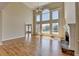 Living room featuring hardwood floors, a fireplace, and large windows with a view at 870 Longstone Lndg, Alpharetta, GA 30022