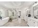 Luxurious bathroom featuring a soaking tub, glass shower, and dual vanities at 870 Longstone Lndg, Alpharetta, GA 30022