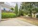 Landscaped backyard with lush, mature trees and small patio at 1052 Pike Forest Ct, Lawrenceville, GA 30045