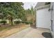 Spacious backyard with mature trees, manicured shrubs, and a patio for outdoor enjoyment at 1052 Pike Forest Ct, Lawrenceville, GA 30045