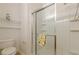 Bathroom featuring a glass-enclosed shower and a toilet with shelving nearby at 1052 Pike Forest Ct, Lawrenceville, GA 30045