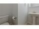 A neutral half bath with pedestal sink and tile flooring at 1052 Pike Forest Ct, Lawrenceville, GA 30045