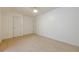 Carpeted bedroom featuring two doors, ceiling light, and ample space at 1052 Pike Forest Ct, Lawrenceville, GA 30045
