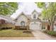 Charming home featuring a one-car garage, lovely landscaping, and large arched window offering natural light at 1052 Pike Forest Ct, Lawrenceville, GA 30045