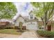 Attractive home boasts a one-car garage and a well-manicured lawn, with ample curb appeal at 1052 Pike Forest Ct, Lawrenceville, GA 30045