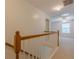 Hallway with carpeted floors and a wooden railing leading to other areas of the house at 1052 Pike Forest Ct, Lawrenceville, GA 30045