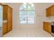 Eat-in kitchen area with a large window view and wood cabinets at 1052 Pike Forest Ct, Lawrenceville, GA 30045