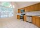 Bright eat-in kitchen has stainless steel appliances and an arched window at 1052 Pike Forest Ct, Lawrenceville, GA 30045