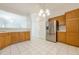 Bright eat-in kitchen with stainless steel refrigerator and a pass-through bar area at 1052 Pike Forest Ct, Lawrenceville, GA 30045