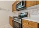 A modern stainless steel oven is installed with matching microwave and mosaic tile backsplash in this kitchen at 1052 Pike Forest Ct, Lawrenceville, GA 30045