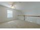 Bright loft space featuring a ceiling fan, window, and railing overlooking the lower level at 1052 Pike Forest Ct, Lawrenceville, GA 30045