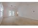 A spacious main bedroom with french doors, a ceiling fan, and neutral carpeting at 1052 Pike Forest Ct, Lawrenceville, GA 30045