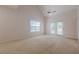 A bright main bedroom with french doors, a ceiling fan, and neutral carpeting at 1052 Pike Forest Ct, Lawrenceville, GA 30045