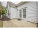 White siding home featuring a patio with double glass paneled doors leading inside at 1052 Pike Forest Ct, Lawrenceville, GA 30045