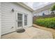 White siding home featuring a patio and double glass paneled doors at 1052 Pike Forest Ct, Lawrenceville, GA 30045