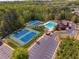 Aerial view of community amenities with sparkling pool, tennis courts, and clubhouse, offering residents a variety of activities at 1060 Crescent Ridge Dr, Buford, GA 30518