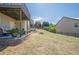 View of the backyard and landscaping, plus the patio with seating underneath the raised deck at 1060 Crescent Ridge Dr, Buford, GA 30518