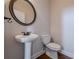 Powder room with pedestal sink and oval mirror at 1060 Crescent Ridge Dr, Buford, GA 30518