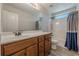 Bathroom with wood vanity, shower/tub combo, toilet, and large mirror at 1060 Crescent Ridge Dr, Buford, GA 30518