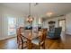 Light-filled dining room boasts an elegant chandelier and wood floors at 1060 Crescent Ridge Dr, Buford, GA 30518