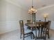 Traditional dining room with wood table, chandelier, wainscoting, and light colored walls at 1060 Crescent Ridge Dr, Buford, GA 30518