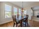 Bright dining area with large windows, hardwood floors, and a modern light fixture at 1060 Crescent Ridge Dr, Buford, GA 30518