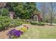 Landscaped community entrance with colorful flowerbeds and stone signage, creating a welcoming first impression at 1060 Crescent Ridge Dr, Buford, GA 30518