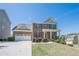 Beautiful home with a brick facade, two-car garage, manicured landscaping, and a welcoming front porch at 1060 Crescent Ridge Dr, Buford, GA 30518