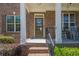 Welcoming front porch with a brick entryway and white pillars, enhancing curb appeal at 1060 Crescent Ridge Dr, Buford, GA 30518