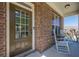 Inviting front porch with brick facade and rocking chairs, a perfect spot to relax and enjoy the neighborhood at 1060 Crescent Ridge Dr, Buford, GA 30518