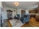 Cozy living room with wood flooring, fireplace, and view of the open kitchen at 1060 Crescent Ridge Dr, Buford, GA 30518