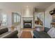 Open-concept living room with wood flooring, fireplace, and view of the staircase at 1060 Crescent Ridge Dr, Buford, GA 30518