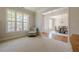Bright living room with a cozy armchair, large window, and open access to the dining area at 1060 Crescent Ridge Dr, Buford, GA 30518