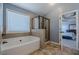 Spacious primary bath with a tub and separate glass enclosed shower at 1060 Crescent Ridge Dr, Buford, GA 30518