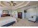 Bright main bedroom with a tray ceiling, carpeting and lots of light at 1060 Crescent Ridge Dr, Buford, GA 30518