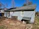 View of the home's exterior and small yard, with some mature trees providing shade and character at 1703 Stanton Sw Rd, Atlanta, GA 30311