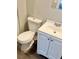 Bathroom showcasing a clean white toilet and sink with white cabinets at 1703 Stanton Sw Rd, Atlanta, GA 30311