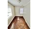 Cozy bedroom featuring hardwood floors, neutral walls, and natural light from two windows at 1703 Stanton Sw Rd, Atlanta, GA 30311
