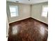 Bedroom with hardwood floors and two windows, offering ample natural light at 1703 Stanton Sw Rd, Atlanta, GA 30311