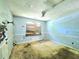 A bedroom needing renovations, featuring a boarded-up window and textured ceiling with a fan at 35 Belmont Way, Covington, GA 30016
