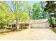 Single story home featuring a garage and front yard with mature trees providing shade at 35 Belmont Way, Covington, GA 30016