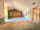 Spacious living room featuring a fireplace, exposed studs, and wood paneling at 35 Belmont Way, Covington, GA 30016