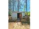The shed features a wooden deck and open door revealing its potential uses for storage or a workshop at 35 Belmont Way, Covington, GA 30016