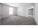 This bedroom features carpet flooring, a window, and a closet at 2374 Rolling Acres Sw Dr, Conyers, GA 30094